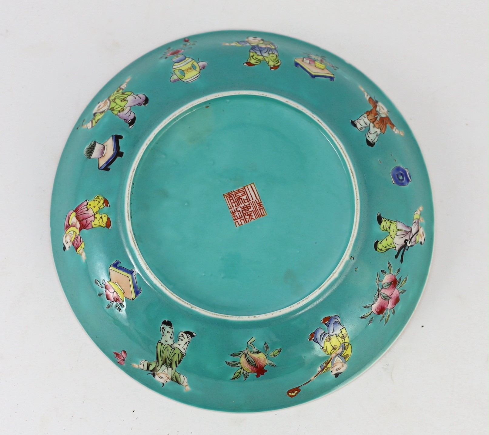 A Chinese turquoise ground 'Boys' dish, Jiaqing seal mark but Republic period, 23.5cm diameter, two hairline cracks